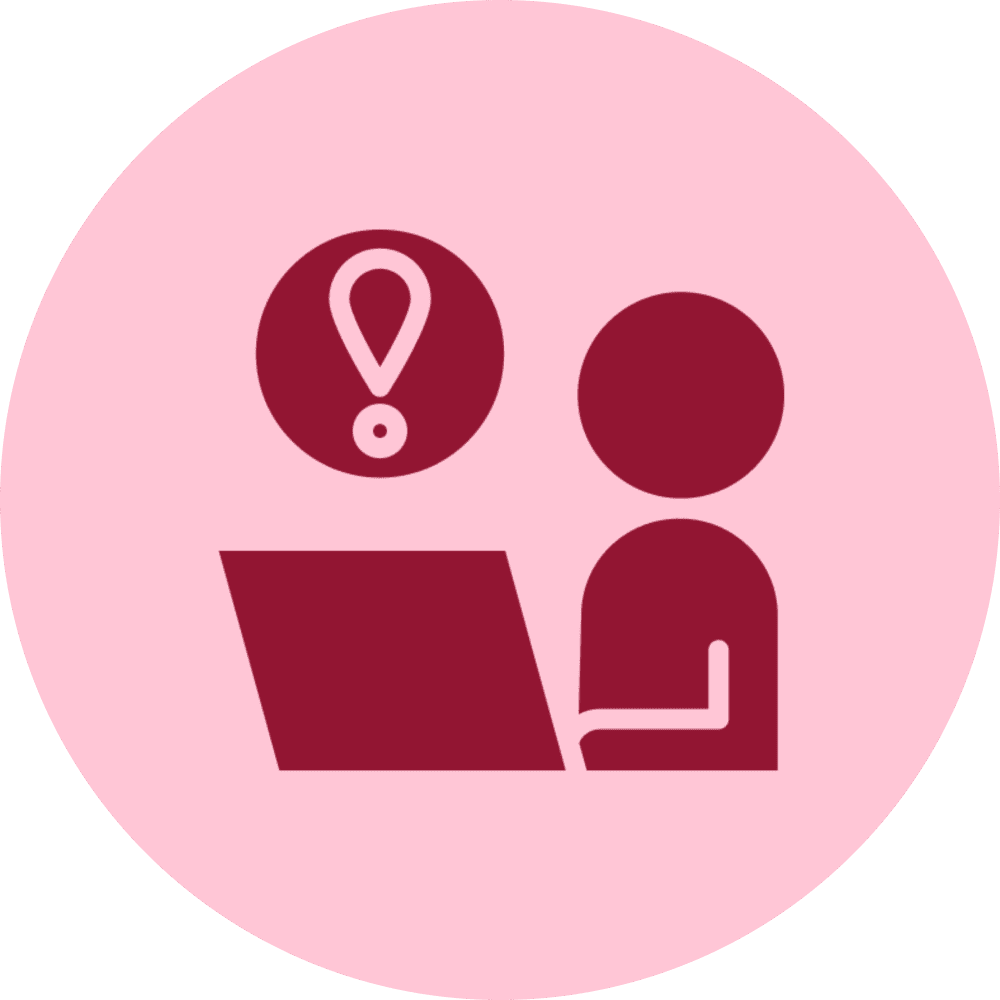 Person at laptop with an alert symbol above.